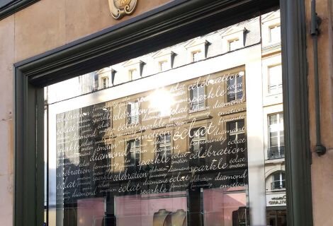 A shopping window embellished with lettering crafted from signage vinyl, showcasing brand names, promotions, or messages in a visually striking and attention-grabbing manner.