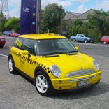 A yellow taxi car adorned with signage vinyl, displaying advertisements, taxi company logos, or other promotional messages, adding a vibrant and eye-catching element to the vehicle's exterior. | © Orafol 